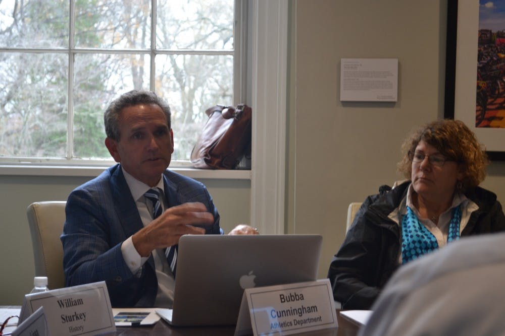 <p>UNC Athletic Director Bubba Cunningham and Jaye Cable discuss the minutes during the Faculty Executive Committee Meeting on Tuesday, Sept. 10, 2019.&nbsp;</p>
<p><br></p>