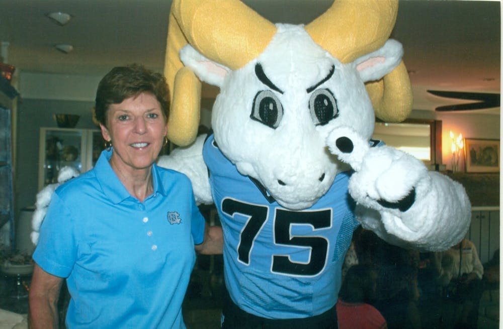 <p>Beth Miller posing with Rameses, the mascot of UNC Athletics, in the home of former fencing head coach Ron Miller.&nbsp;</p>
<p>Photo courtesy of UNC Athletic Communications.</p>