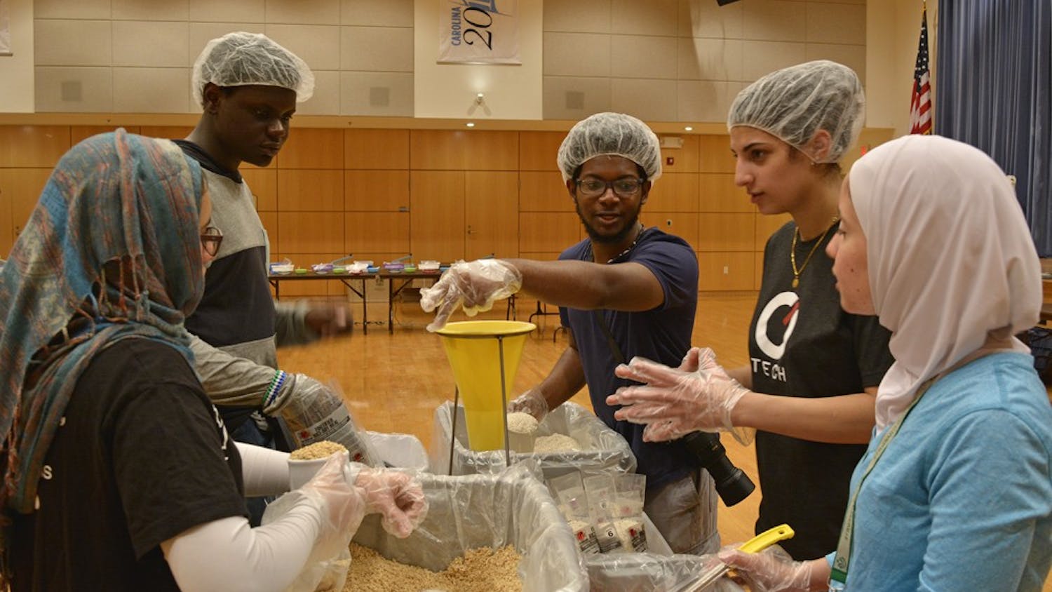 Volunteers from the UNC Muslim Student Association partnered with Rise Against Hunger (formerly Stop Hunger Now) to host a meal-packaging event in the Great Hall on Sunday, February 12. The event was held in remembrance of Our Three Winners.