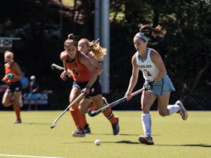 Freshman forward Erin Matson (1) Of UNC Field Hockey team battles for the ball against Syracuse in a 5-1 win on Saturday, Sept. 29, at Karen Shelton Stadium in Chapel Hill, NC. 