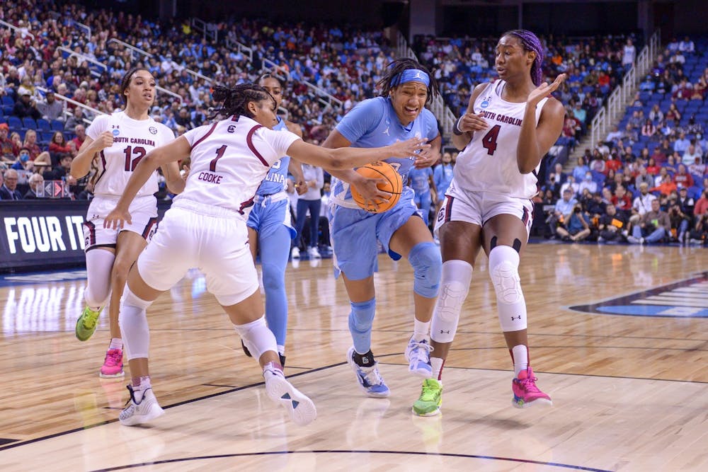 <p>Sophomore guard Kennedy Todd-Williams (3) fights to defend the ball in the UNC women’s basketball game against No. 1 South Carolina on Friday, March 25, 2022. The Tar Heels lost, 69-61.</p>
