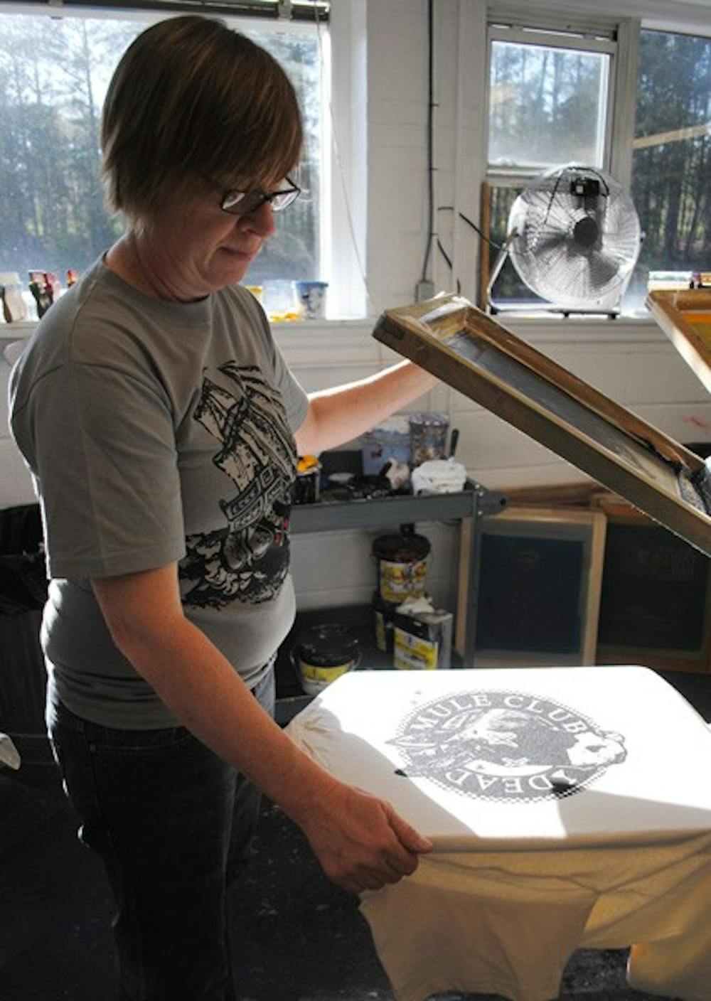 Melanie Wall, of Bread and Butter Screen Printing, prints a “Dead Mule Club” T-shirt at her shop in Chapel Hill on Wednesday.