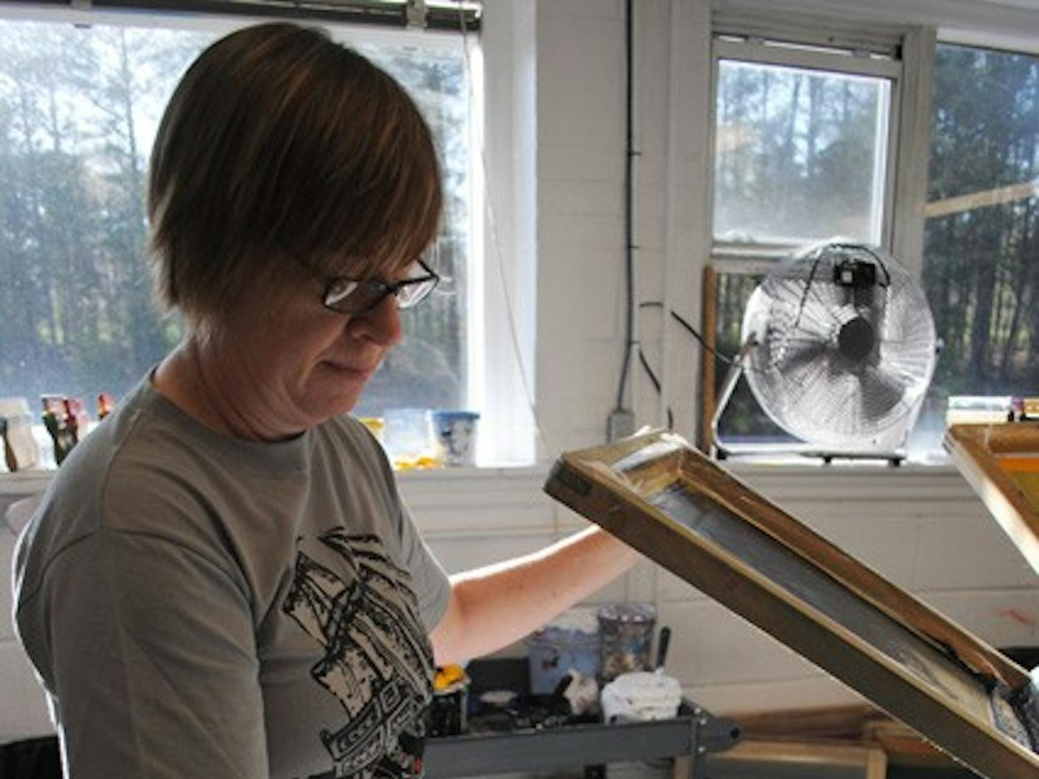 Melanie Wall, of Bread and Butter Screen Printing, prints a “Dead Mule Club” T-shirt at her shop in Chapel Hill on Wednesday.