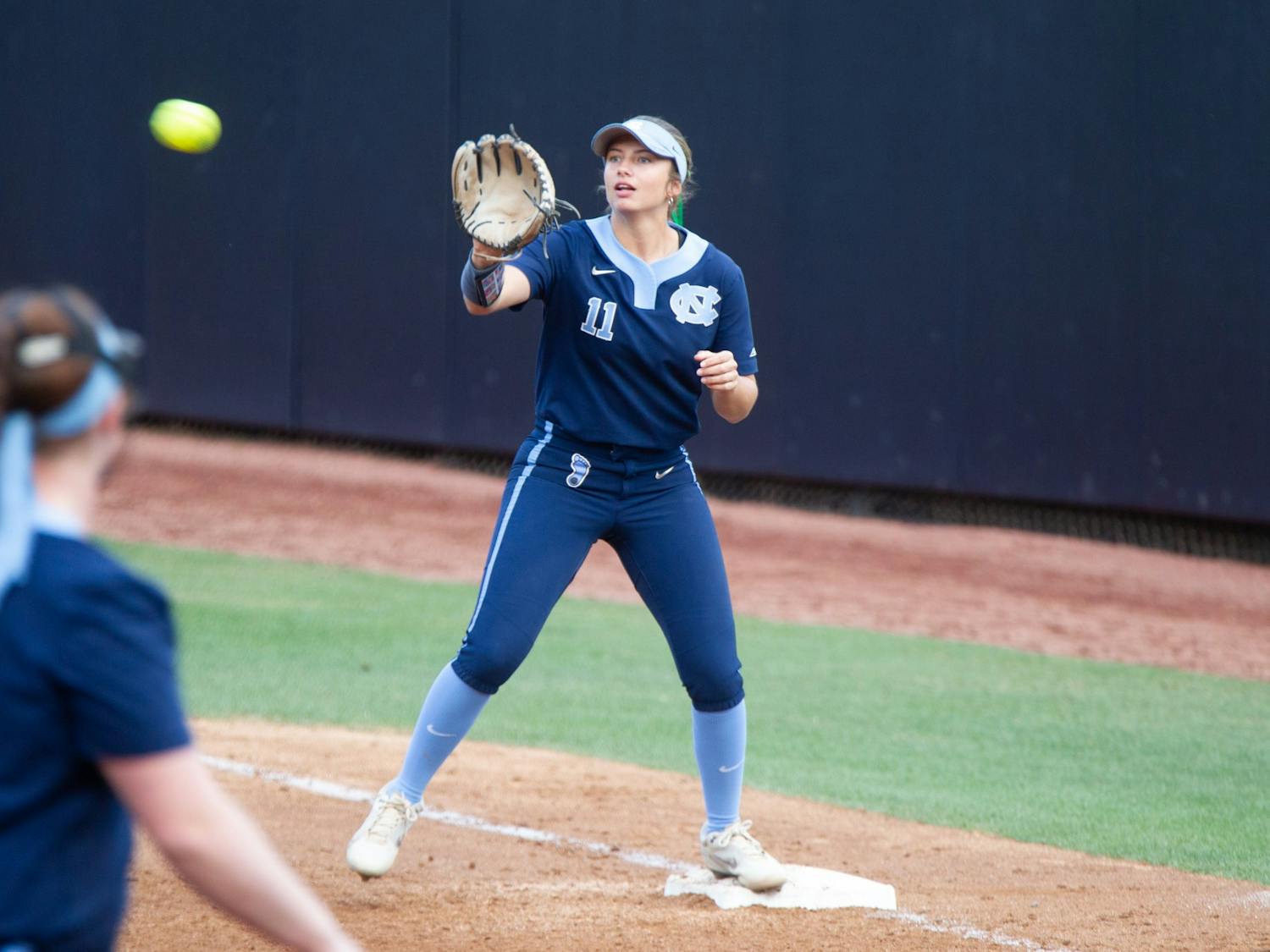 UNC junior infielder Katie Perkins (11) catches the ball at first base to get a runner out during a home game against N.C. Central at Anderson Stadium on Wednesday, Apr. 20, 2022.