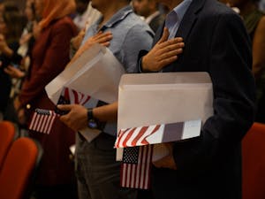 Soon-to-be citizens sing the national anthem at the naturalization ceremony on April 12, 2019 at the FedEx Global Education Center.