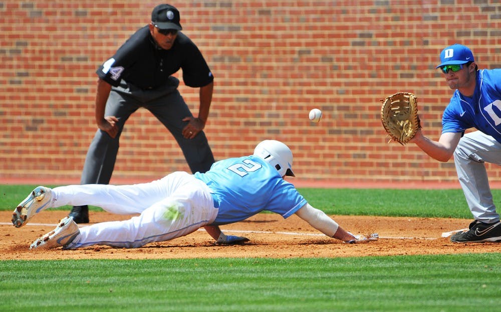 	Chaz Frank dives back toward the bag during Sunday’s game.  The senior outfielder was one-for-five on Sunday but totaled four hits on the weekend. 