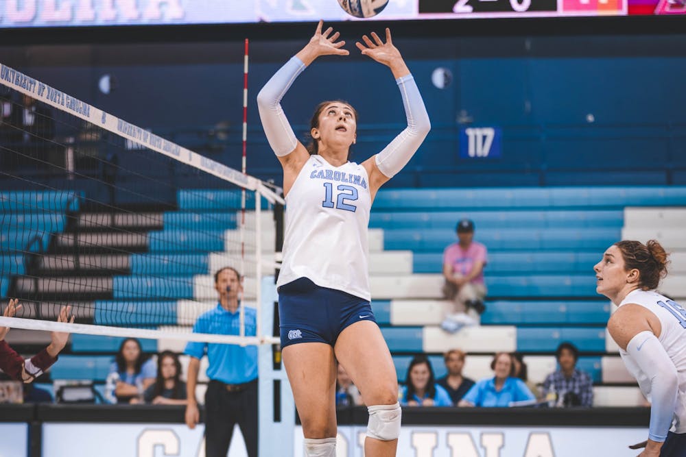 UNC freshman Anita Babic (12) sets near the end of the third set of the volleyball game against Boston College on Friday, Oct. 14, 2022. UNC won 3-0.