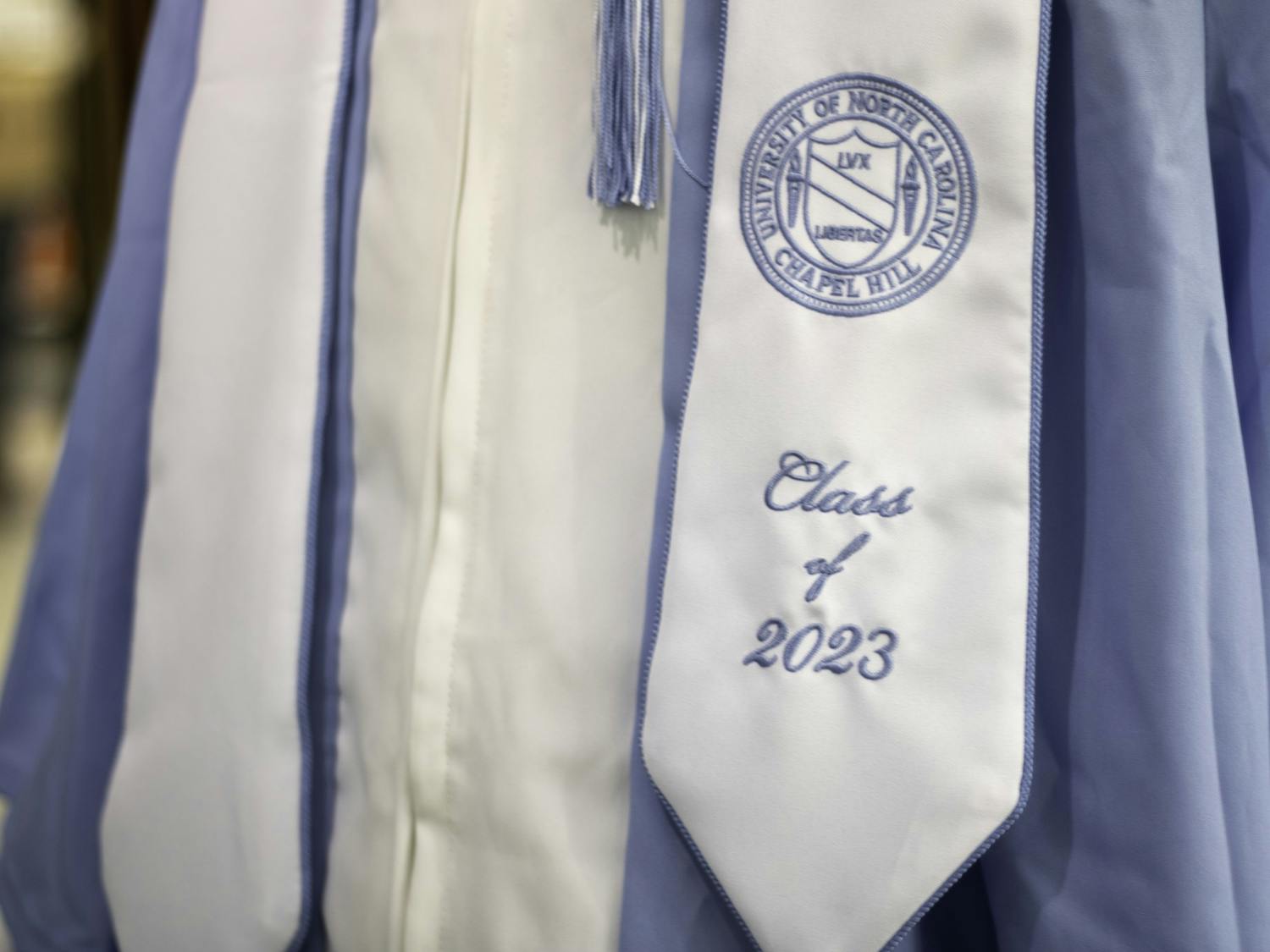 A UNC graduation gown being displayed in the Student Stores on Wednesday, April 12, 2023.