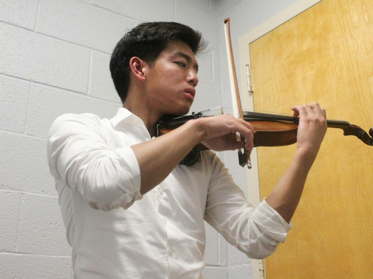 Junior biology major Thoai Vu practicing the violin in Hill Hall on Tuesday, Oct. 22, 2019. Vu is the president and founder of Heeling in Harmony. Vu said that the club "aims to promote healing and improve quality of life through music and music related activities."