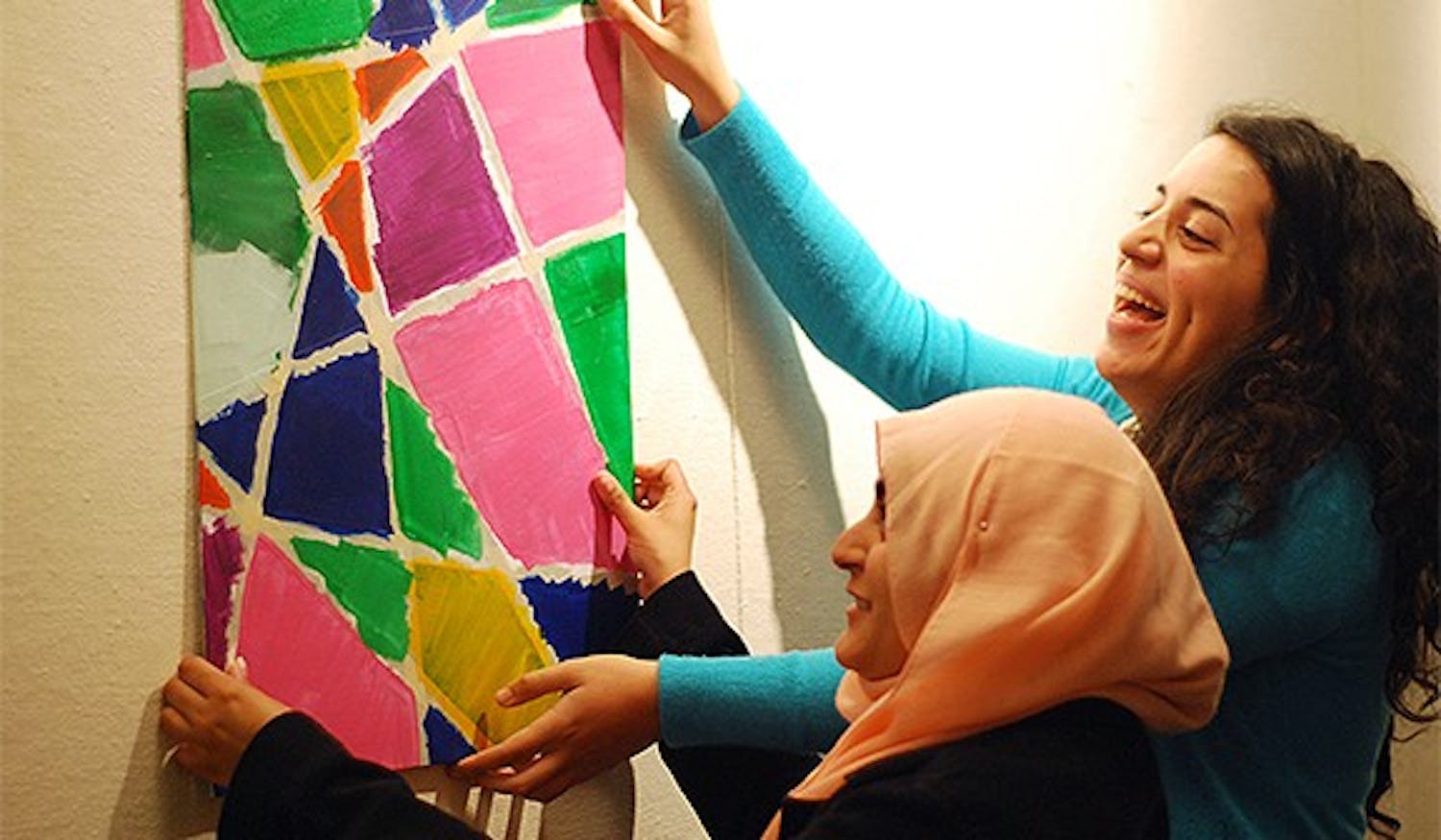 A group of UNC students are having a multimedia exhibition in the union on Wednesday. Features Muslims in the Triangle as they pursue their passions or interests. From left, Aisha Anwar,sophomore, and Layla K Quran, junior, are running the event. 