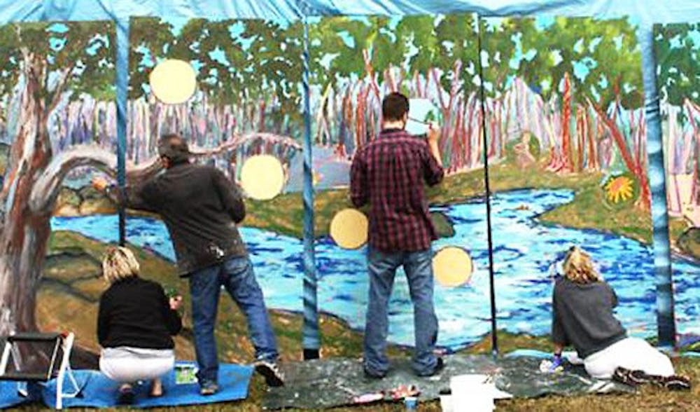 Julie Jones, Joe DiSabatino, Matt Fields and Ginny Chancel help paint a mural of Bolin Creek. Courtesy of Wes Tilghman