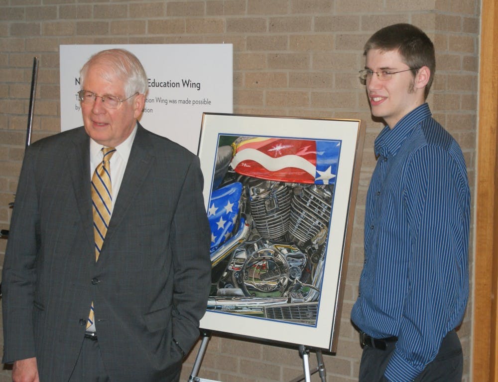 	<p>Sean Stickel of Chapel Hill, right, stands with his winning artwork and Rep. David Price. Photo courtesy the Office of Congressman David Price.</p>