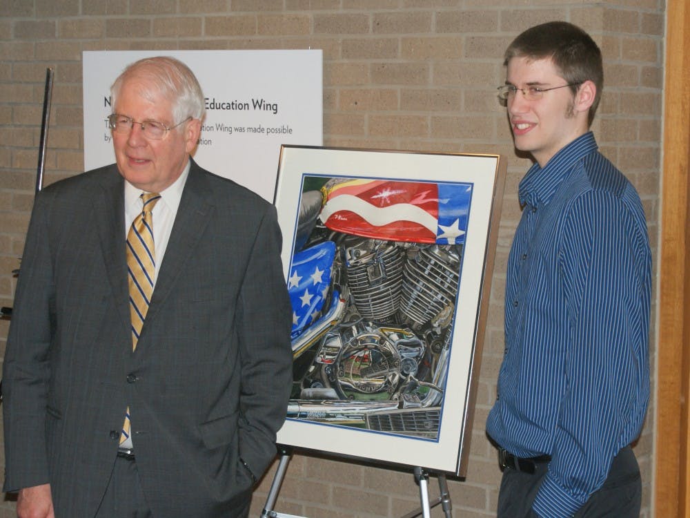 	Sean Stickel of Chapel Hill, right, stands with his winning artwork and Rep. David Price. Photo courtesy the Office of Congressman David Price.