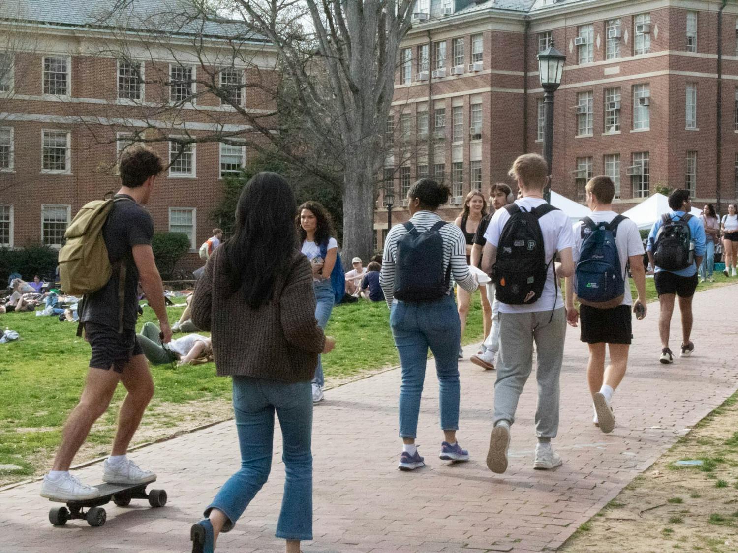 Students traverse the university grounds in different styles on Monday, March 6, 2023.
