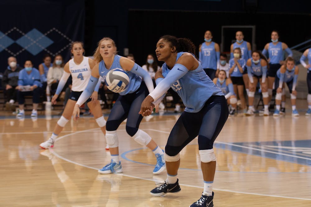 Graduate outside hitter Nia Robinson (18) prepares to receive the ball and pass to a teammate in an intense match against Wake Forest at Carmichael Arena on Oct. 8. The Tar Heels defeated the Demon Deacons 3-2.
