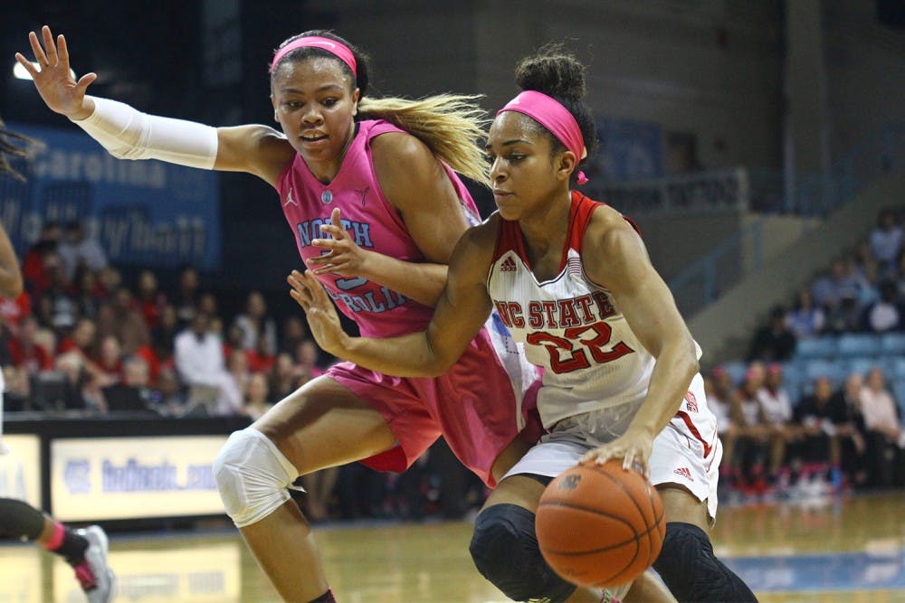 <p>First-year guard Stephanie Watts (5) guards Dominique Wison&nbsp;(22)&nbsp;during the game against N.C. State.</p>