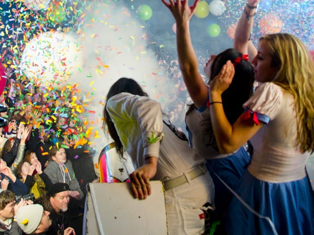 	A member of the Flaming Lip&#8217;s production crew aims a confetti cannon above the crowd at Moogfest 2011. 