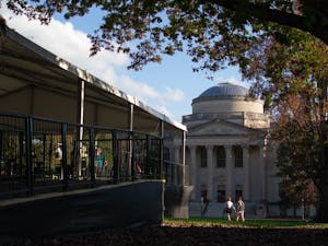 Students study at the outdoor and socially-distanced study area the University built on Polk Place as other students walk past Wilson Library on Sunday, Nov. 15, 2020.