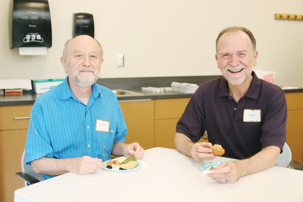 	Tim Williams and Dave Durham of Chapel Hill enjoyed the &#8220;Gay and Gray&#8221; event at the Seymour Center on Homestead Road. 
