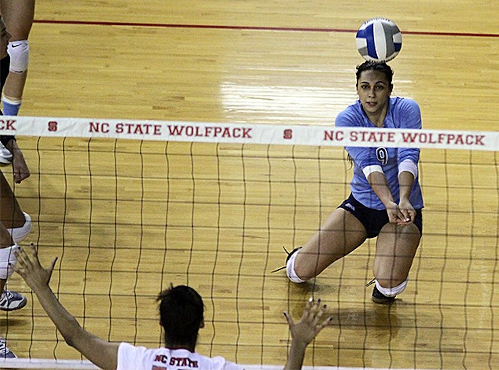 	UNC junior defensive specialist Ece Taner (9) digs a ball in Wednesday night&#8217;s game against N.C. State. UNC won the match 3-0. 