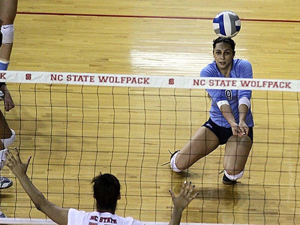 	UNC junior defensive specialist Ece Taner (9) digs a ball in Wednesday night&#8217;s game against N.C. State. UNC won the match 3-0. 