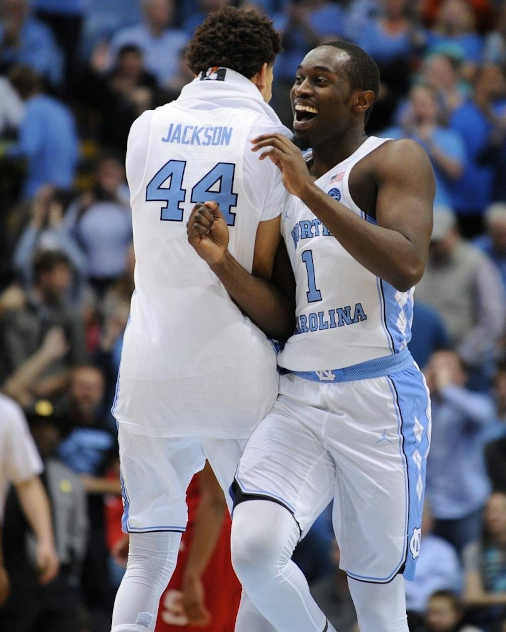 Junior Theo Pinson (1) celebrates with Justin Jackson (44) after a play during the N.C. State game on Jan. 8. The win over the Wolfpack&nbsp;was Pinson's first game this season after missing the first 16 contests with a broken foot.