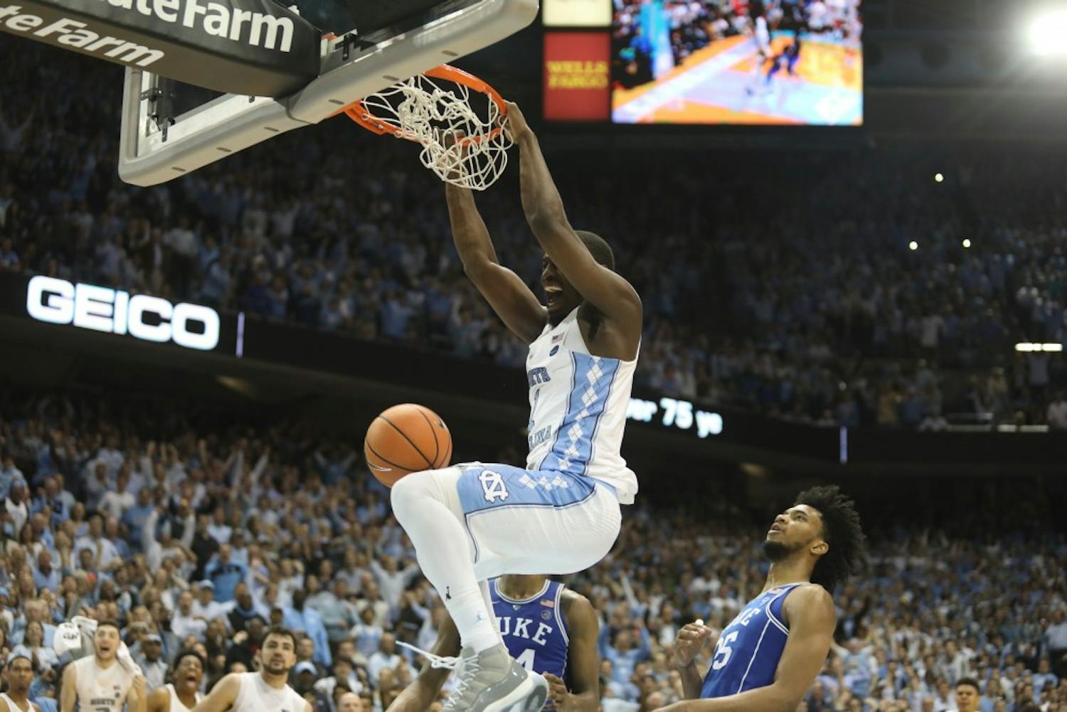 Forward Theo Pinson (1) dunks in the final seconds of UNC's 82-78 win over Duke on Thursday night in the Smith Center.
