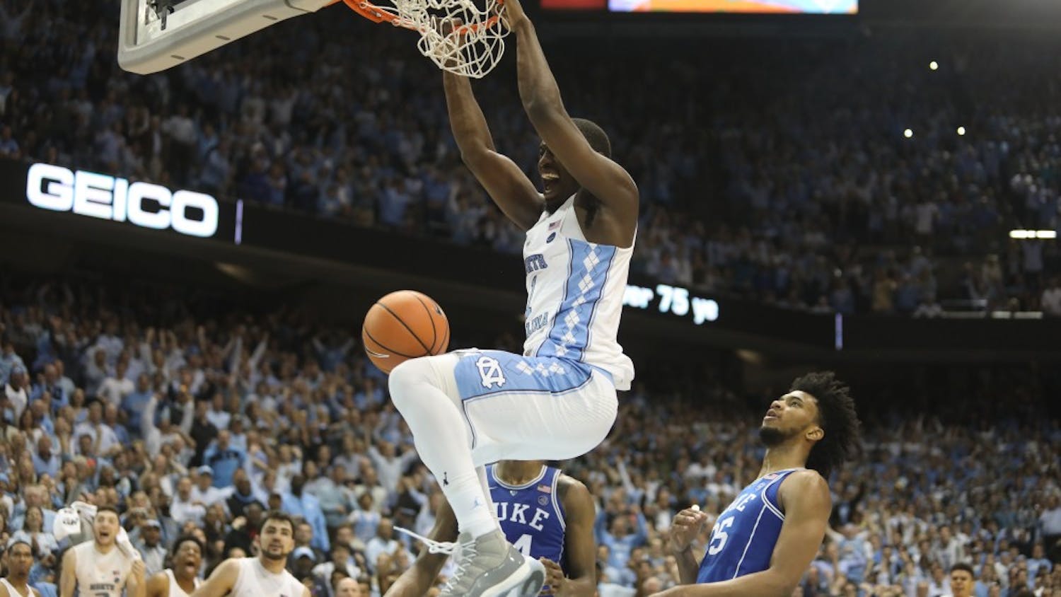 Forward Theo Pinson (1) dunks in the final seconds of UNC's 82-78 win over Duke on Thursday night in the Smith Center.