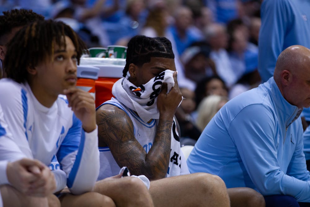 <p>UNC junior guard Caleb Love (2) hides his face behind a towel during the men’s basketball game against Duke in the Dean E. Smith Center on Saturday, March 4, 2023. UNC fell to Duke 62-57.</p>