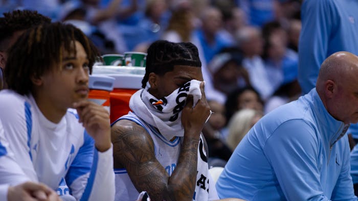 UNC junior guard Caleb Love (2) hides his face behind a towel during the men’s basketball game against Duke in the Dean E. Smith Center on Saturday, March 4, 2023. UNC fell to Duke 62-57.