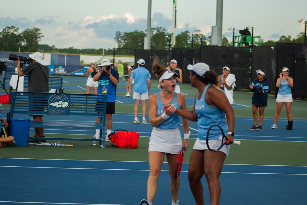<p>Junior Fiona Crawley (left) and graduate student Abbey Forbes celebrate after winning a game against N.C. State on May 20, 2023. The Tar Heels went on to win the match, 4-1.</p>