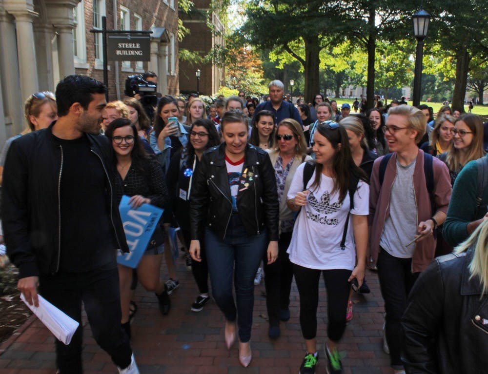 Lena Dunham leads a march with a heard of UNC students in tow to the early voting site at Chapel of the Cross. 