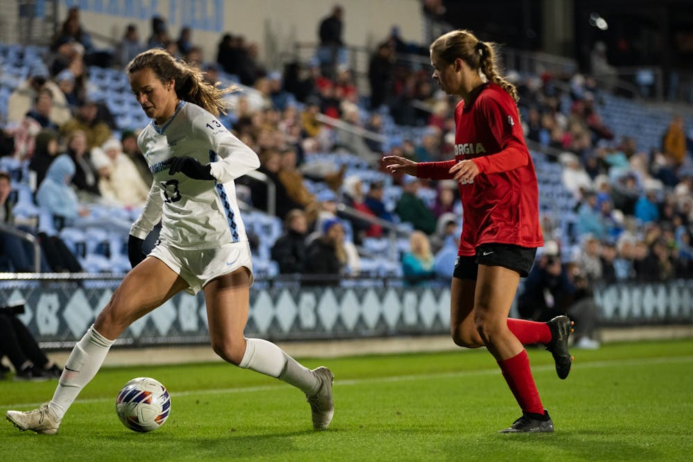 UNC senior forward Isabel Cox (13) protects the ball during the women's soccer game against Georgia on Thursday, Nov. 17, 2022, at Dorrance Field. UNC beat Georgia 3-1.