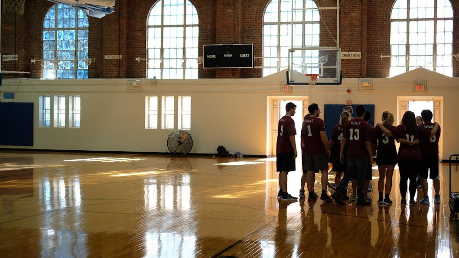 The BB&amp;T team huddles before a game at the Phil Ford charity basketball tournament Tuesday evening in Woollen Gym.