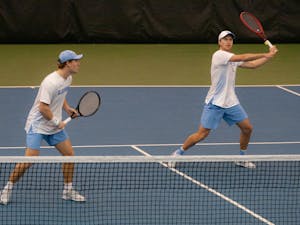 Senior Brian Cernoch looks to volley during a doubles match against Bucknell University at the Cone-Kenfield Tennis Center on Sunday, Jan. 23, 2022. The Heels won 7-0.