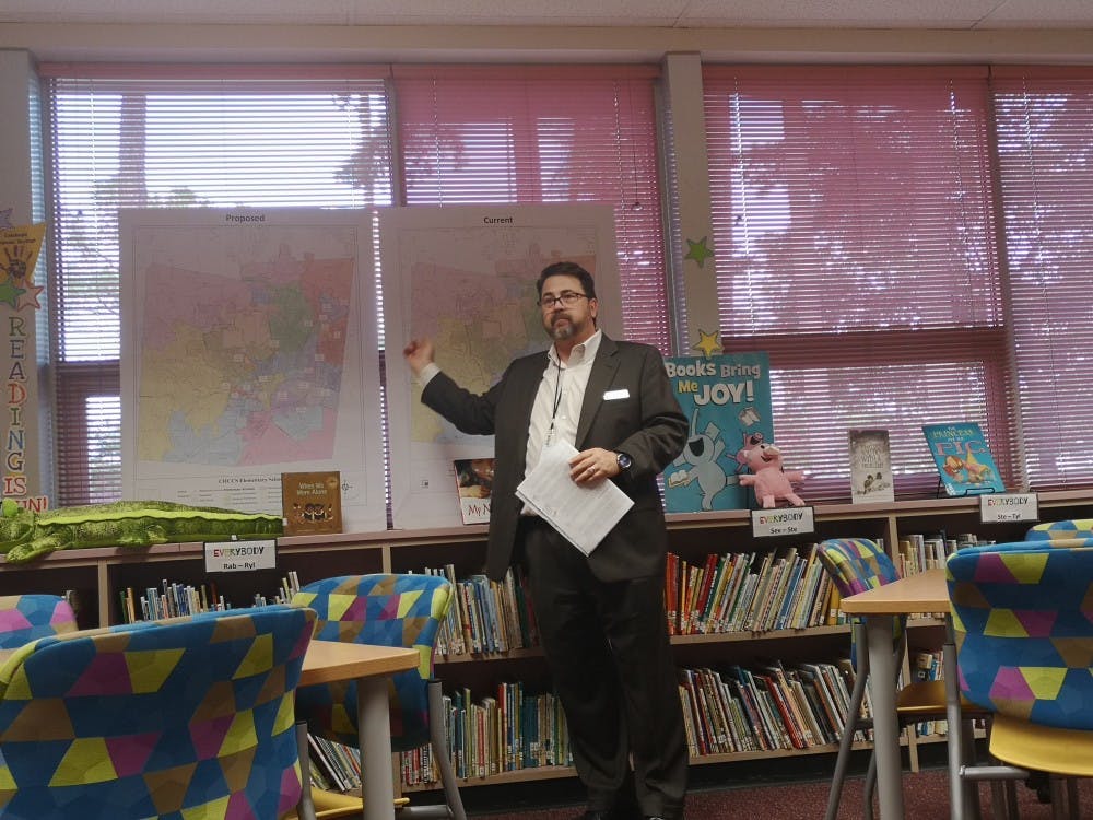 Patrick Abele, assistant superintendent of CHCCS, talks about the proposed and current assignment zones of Glenwood Elementary during the family input session on Monday, Oct. 21, 2019.