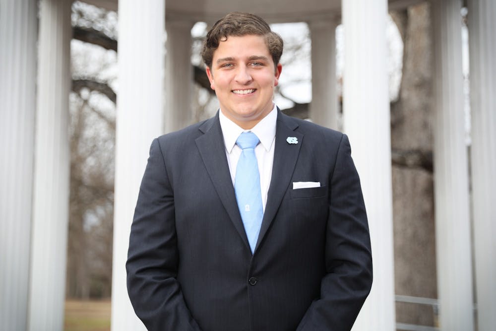 Sam Robinson, a candidate for student body president, stands in front of the Old Well on Thursday, Feb. 3, 2022.  