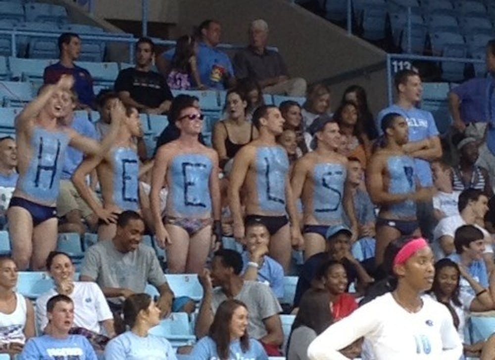 	Members of the UNC men&#8217;s swim team cheer on the volleyball team Friday night at Carmichael Arena. 
