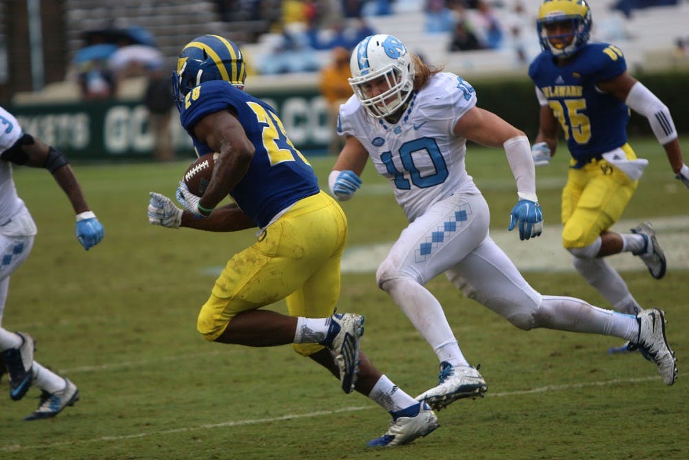 Linebacker Jeff Schoettmer (10) chases down Thomas Jefferson (28) before his tackle in the third quarter. 