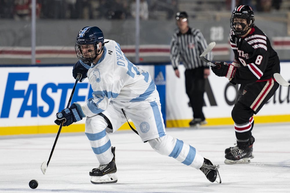 UNC forward Dan O'Hear (77) moves toward the goal with the puck during the ice hockey game at Carter-Finley Stadium on Monday, Feb. 20, 2023. UNC lost 7-3.