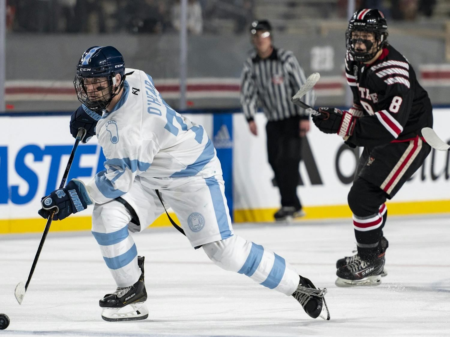 UNC forward Dan O'Hear (77) moves toward the goal with the puck during the ice hockey game at Carter-Finley Stadium on Monday, Feb. 20, 2023. UNC lost 7-3.