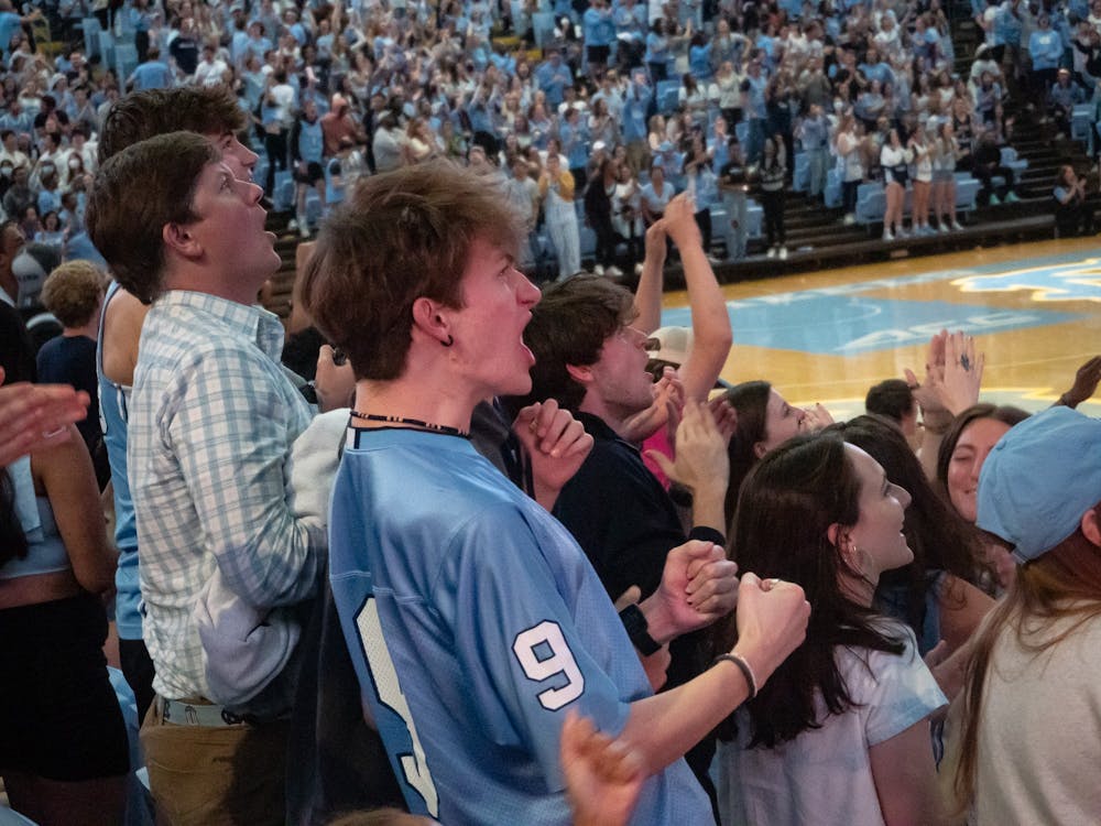 <p>A student cheers during the NCAA men's basketball championship game against Kansas in the Dean E. Smith Center on Monday, April 4, 2022.&nbsp;</p>