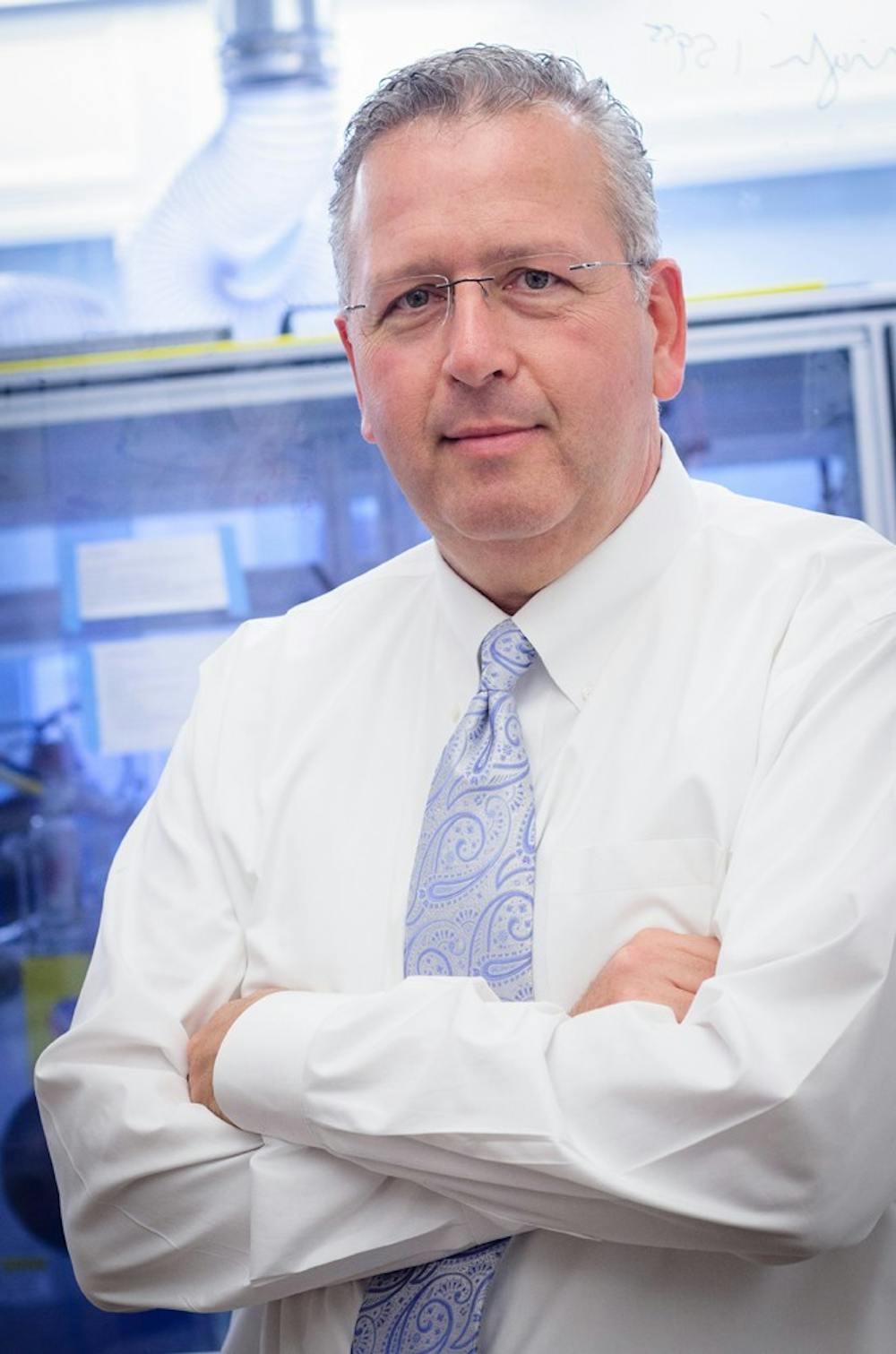 Professor Joseph DeSimone pictured in front of the roll-to-roll particle-fabrication unit housed at UNC-Chapel Hill's Caudill Labs. Roll-to-roll fabrication technology is used in the manufacture of vaccines and medicines.