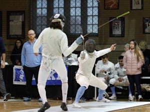 Sophomore foil Anders Hartmark lunges for opponent in a bout against MIT University at the Card Gymnasium on Saturday, Feb. 8, 2020. UNC won this round 6-3 and beat MIT overall 16-11.