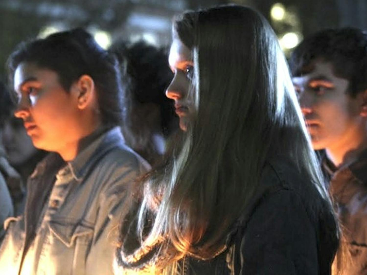 Students gathered on the steps of Wilson Library to attend a vigil honoring the lost and threatened lives in the transgender community on Transgender Day of Remembrance in 2015.