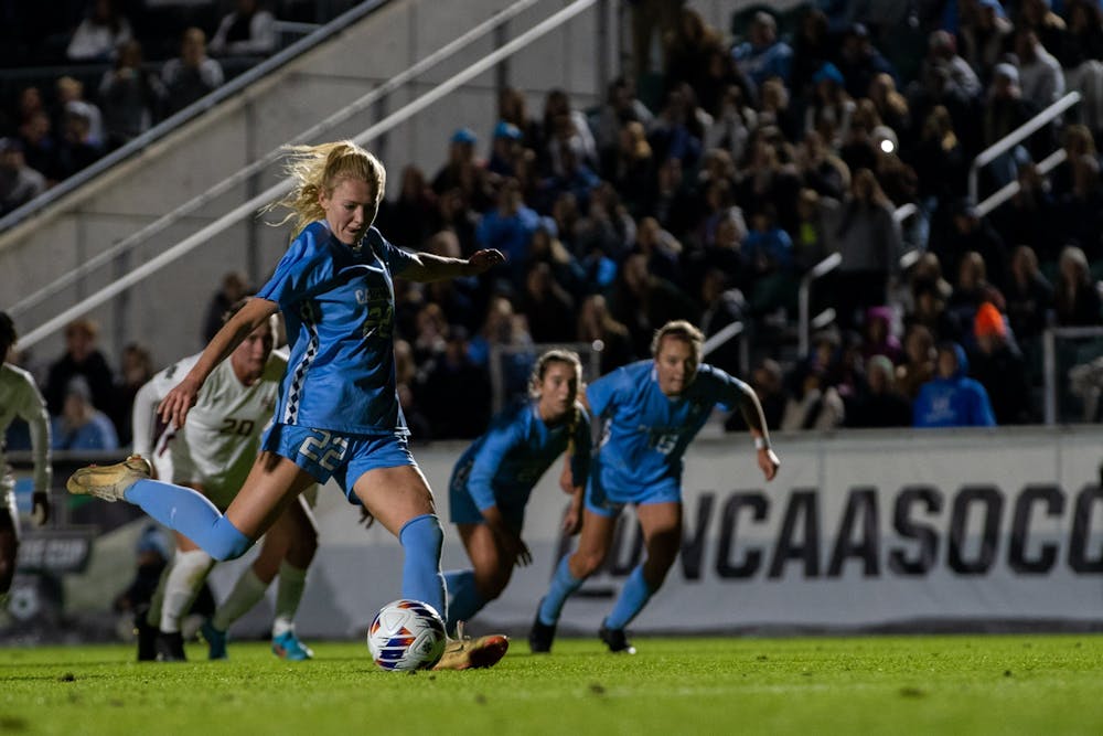 UNC senior defender Tori Hansen (22) scores a penalty kick during UNC's game against FSU in the NCAA semifinals at WakeMed Soccer Park on Friday, Dec. 2, 2022. UNC won 3-2.
