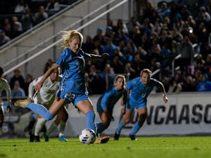 UNC senior defender Tori Hansen (22) scores a penalty kick during UNC's game against FSU in the NCAA semifinals at WakeMed Soccer Park on Friday, Dec. 2, 2022. UNC won 3-2.