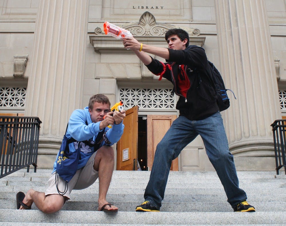 Freshmen Ethan Butler (left) and Andrew Burchins (right) pose as humans on the steps of Wilson Library on Monday afternoon. The two are participating in the campus-wide Humans v. Zombies game, which lasts through Friday. 