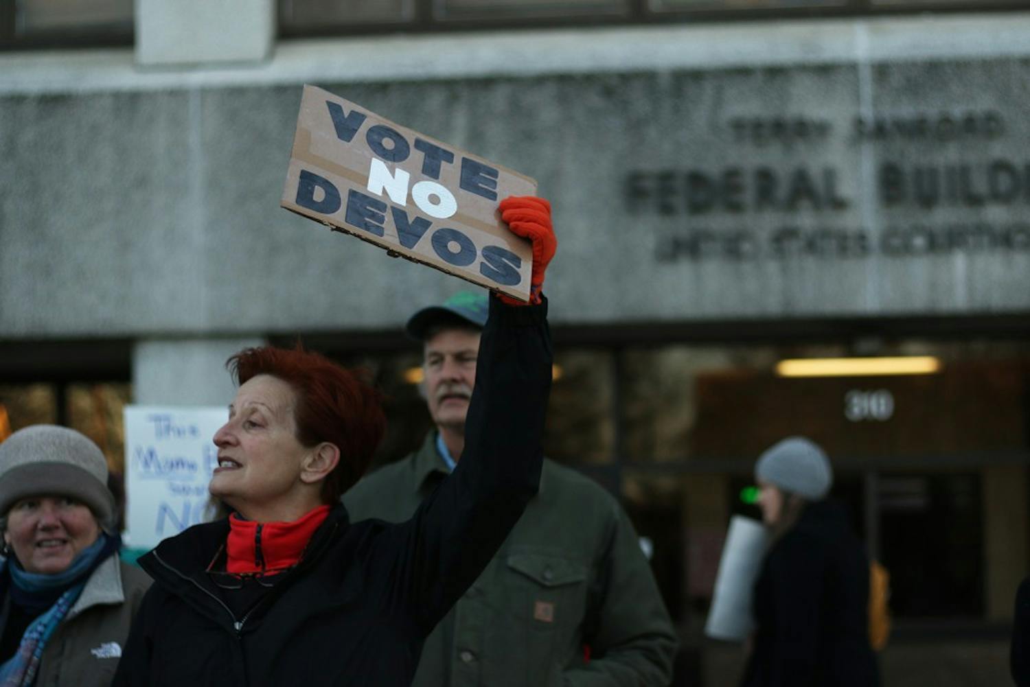 Michele Cox from Newton Grove, NC stands in front of the Federal Courthouse Building to ask Senator Tillis to vote no to Betsy DeVos.
