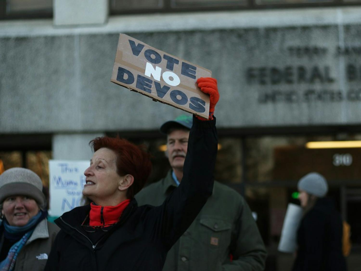 Michele Cox from Newton Grove, NC stands in front of the Federal Courthouse Building to ask Senator Tillis to vote no to Betsy DeVos.